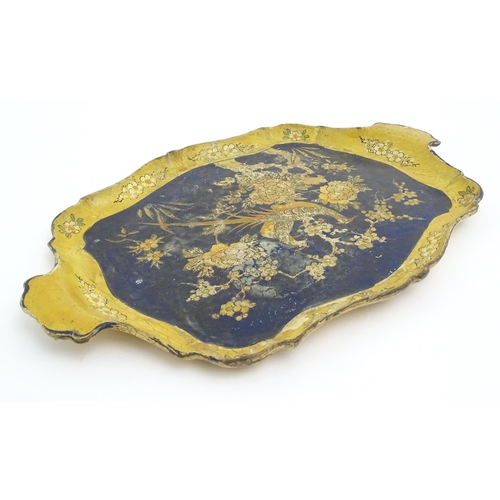 991 - A 19thC lacquered papier mache tray of shaped form decorated with exotic birds amongst flowers and f... 