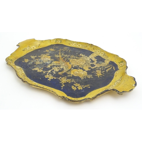 991 - A 19thC lacquered papier mache tray of shaped form decorated with exotic birds amongst flowers and f... 