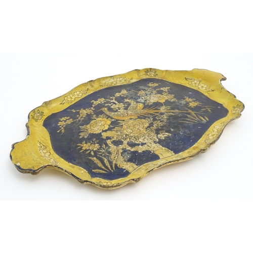 991 - A 19thC lacquered papier mache tray of shaped form decorated with exotic birds amongst flowers and f... 