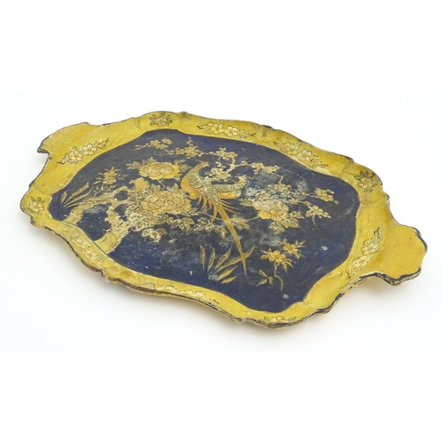 991 - A 19thC lacquered papier mache tray of shaped form decorated with exotic birds amongst flowers and f... 