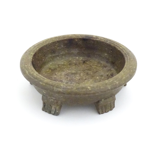 996 - An Oriental stone dish with reeded rim and mica style decoration standing on five feet. Approx. 4