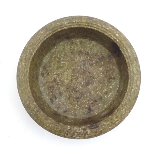 996 - An Oriental stone dish with reeded rim and mica style decoration standing on five feet. Approx. 4