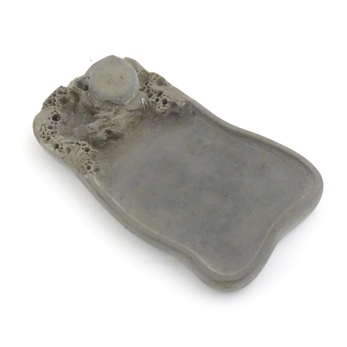 998 - A Chinese soapstone inkstone with carved stylised turtle and waves to well. Within a fitted wooden b... 