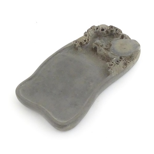 998 - A Chinese soapstone inkstone with carved stylised turtle and waves to well. Within a fitted wooden b... 