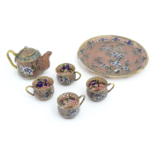 999 - A plique a jour miniature tea set comprising teapot, four cups and a circular tray, each decorated w... 