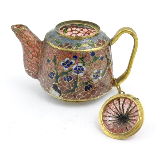 999 - A plique a jour miniature tea set comprising teapot, four cups and a circular tray, each decorated w... 