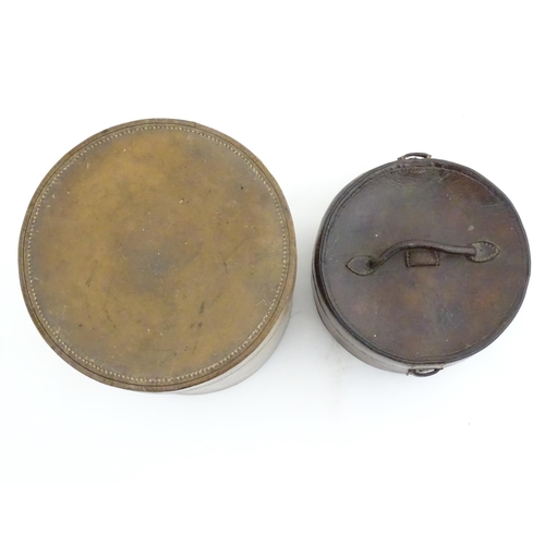 1030 - A 20thC leather collar box. Together with another leather muff box of cylindrical form. Largest appr... 