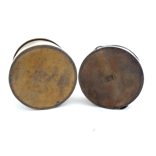 1030 - A 20thC leather collar box. Together with another leather muff box of cylindrical form. Largest appr... 