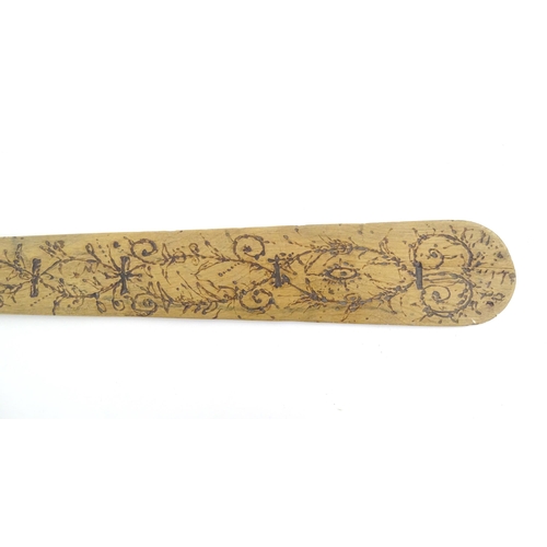 1031 - A 19thC French stay busk with scrolling foliate and fruiting vine pokerwork decoration. Approx. 16