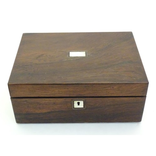 1038 - A Victorian rosewood writing box with inlaid mother of pearl to top, opening to reveal a fitted inte... 