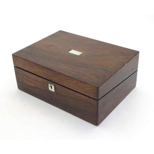 1038 - A Victorian rosewood writing box with inlaid mother of pearl to top, opening to reveal a fitted inte... 