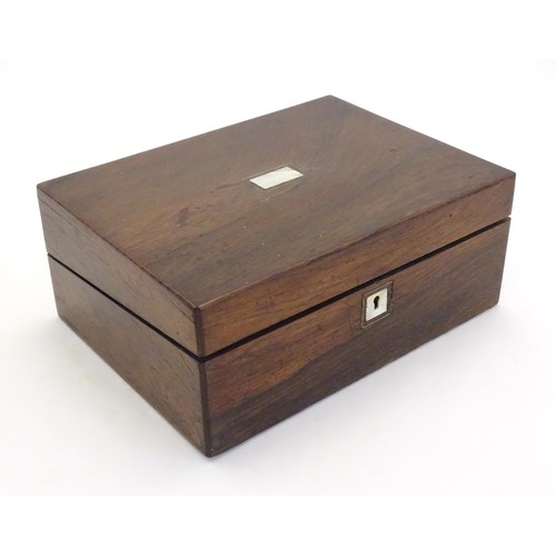 1038 - A Victorian rosewood writing box with inlaid mother of pearl to top, opening to reveal a fitted inte... 