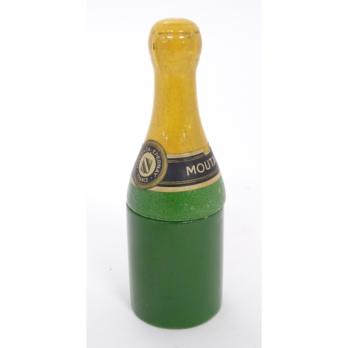 1054 - A 20thC French novelty ceramic mustard pot formed as a champagne bottle. Approx. 6 1/2