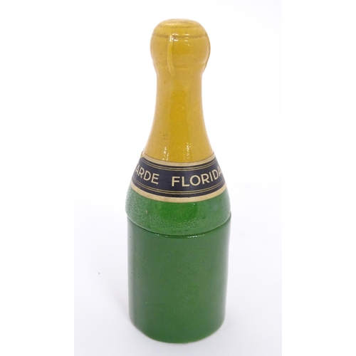 1054 - A 20thC French novelty ceramic mustard pot formed as a champagne bottle. Approx. 6 1/2