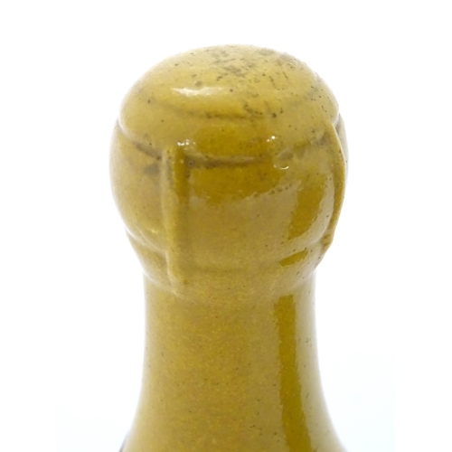 1054 - A 20thC French novelty ceramic mustard pot formed as a champagne bottle. Approx. 6 1/2