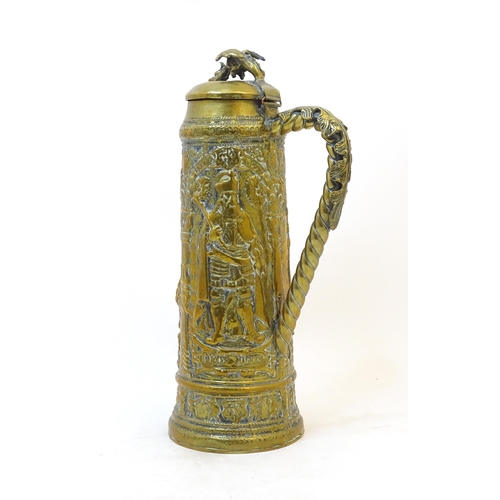 1069 - A late 19 / early 20thC large German brass stein with embossed decoration depicting Pipino, Carolus ... 