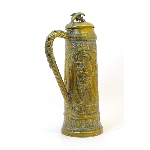 1069 - A late 19 / early 20thC large German brass stein with embossed decoration depicting Pipino, Carolus ... 