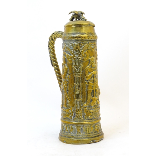 1069 - A late 19 / early 20thC large German brass stein with embossed decoration depicting Pipino, Carolus ... 