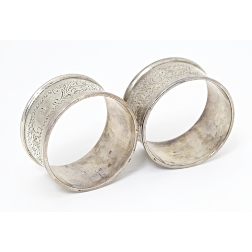 375 - Two silver napkin rings with engraved acanthus scroll decoration, hallmarked Birmingham 1905, maker ... 