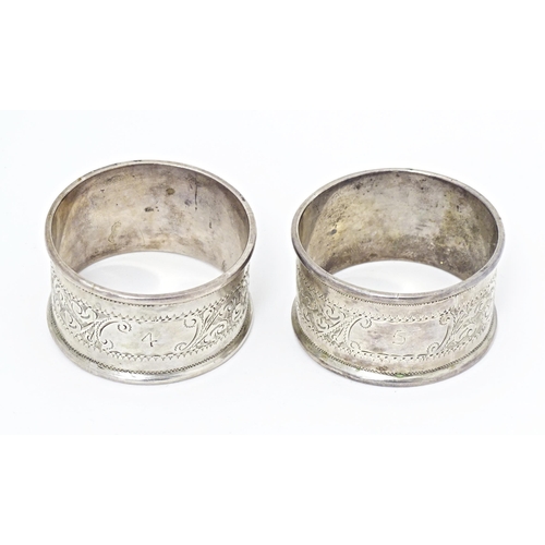 375 - Two silver napkin rings with engraved acanthus scroll decoration, hallmarked Birmingham 1905, maker ... 