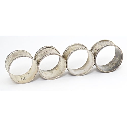 391 - Four various hallmarked silver napkin rings  with engraved decoration. (4)