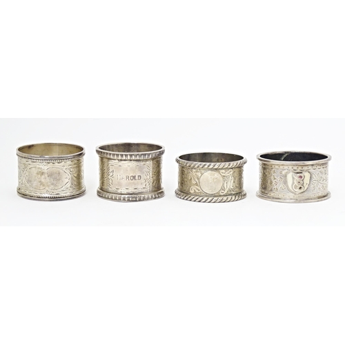 391 - Four various hallmarked silver napkin rings  with engraved decoration. (4)