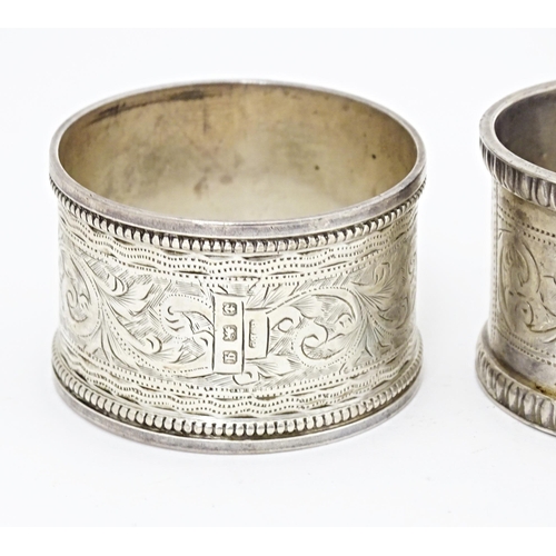 391 - Four various hallmarked silver napkin rings  with engraved decoration. (4)