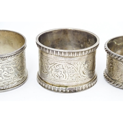 391 - Four various hallmarked silver napkin rings  with engraved decoration. (4)