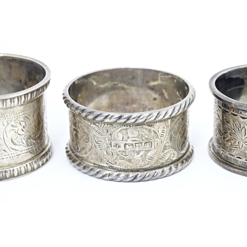 391 - Four various hallmarked silver napkin rings  with engraved decoration. (4)