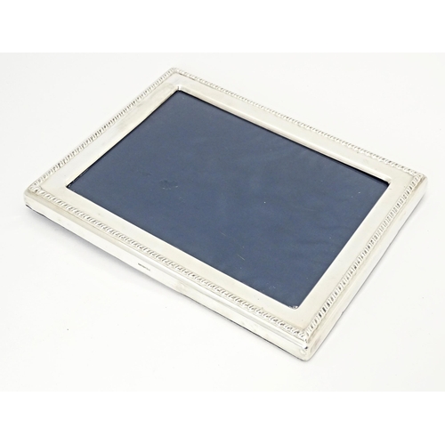 510 - A photograph frame with silver surround hallmarked Sheffield 1992 maker Mappin & Webb. Approx. 8 3/4... 