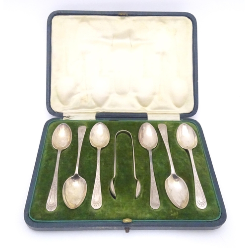 503 - A cased set of six silver teaspoons with tongs en suite, having engraved desecration. Hallmarked She... 