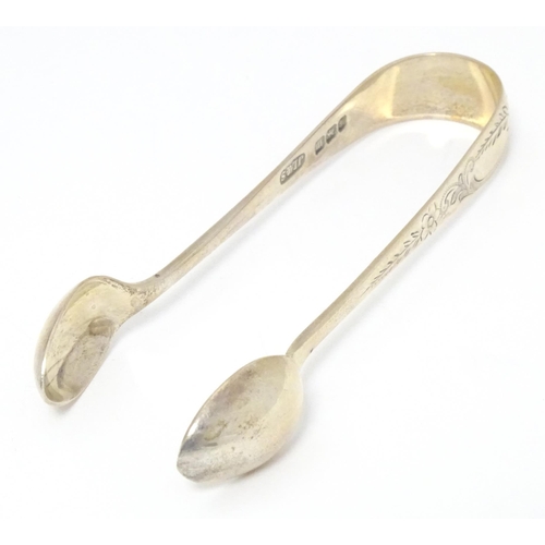 503 - A cased set of six silver teaspoons with tongs en suite, having engraved desecration. Hallmarked She... 