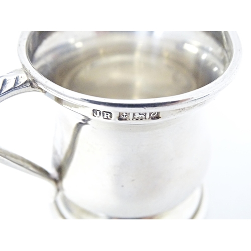 320 - A silver miniature cup / tankard with loop handle hallmarked Birmingham 1963, maker John Rose. Appro... 