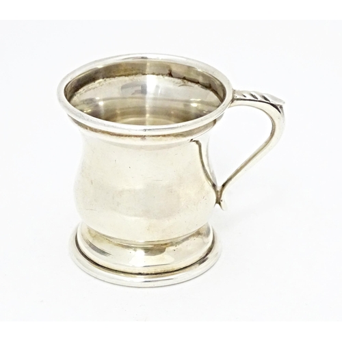 320 - A silver miniature cup / tankard with loop handle hallmarked Birmingham 1963, maker John Rose. Appro... 