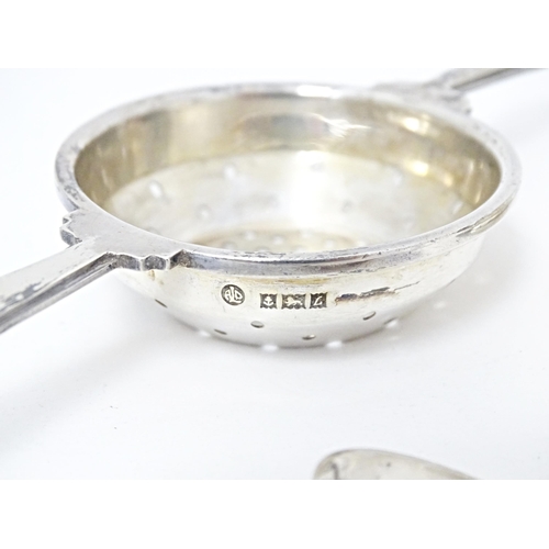 322 - An Art Deco style silver twin handled tea / lemon strainer with stand hallmarked Birmingham 1960, ma... 