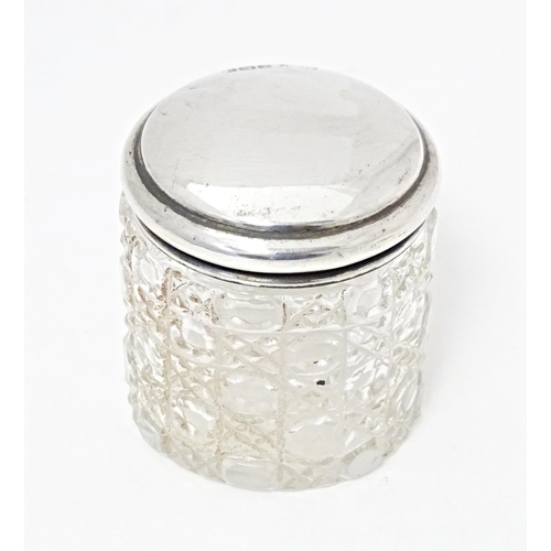 326 - A glass dressing table / toilet jar with silver lid hallmarked Birmingham 1923, maker Marson & Jones... 