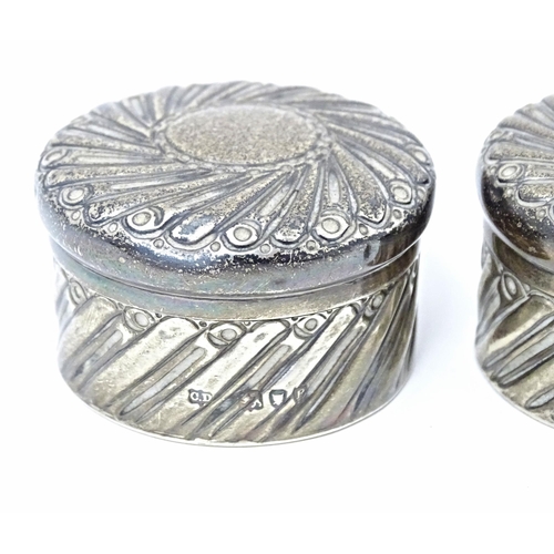 333 - A pair of Victorian silver pots and covers with embossed decoration hallmarked London 1892, maker Ch... 