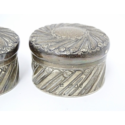 333 - A pair of Victorian silver pots and covers with embossed decoration hallmarked London 1892, maker Ch... 