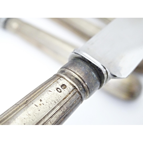 338 - A matched set of twelve Geo III and later silver handled table knives. Approx. 10 1/2