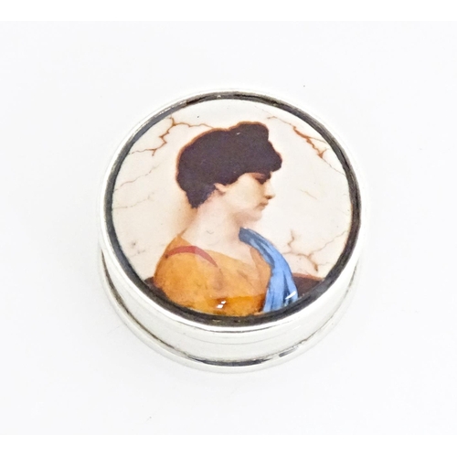 344 - A .925 silver pill box of circular form with enamel portrait to top. Approx. 1