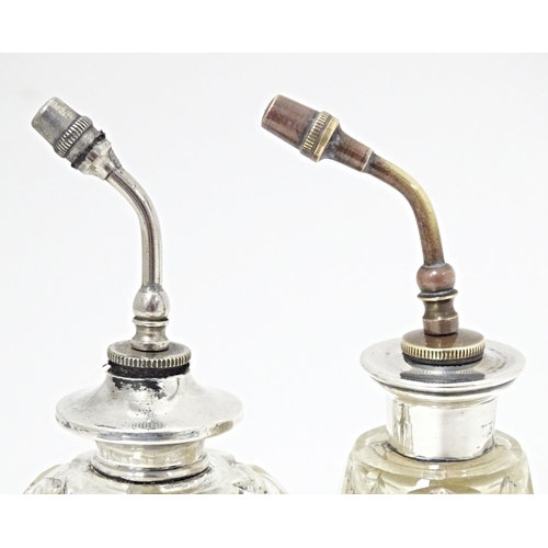 347 - Two cut glass atomisers with silver tops. Largest approx. 4 3/4