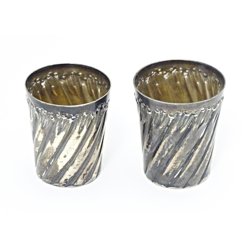 351 - Two French silver plate tot cups with fluted decoration. Largest approx. 1 1/2