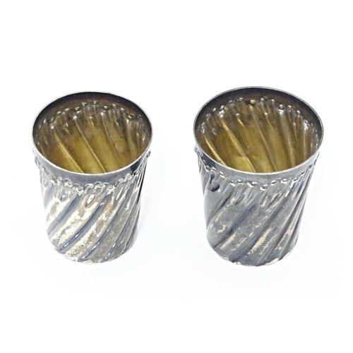 351 - Two French silver plate tot cups with fluted decoration. Largest approx. 1 1/2