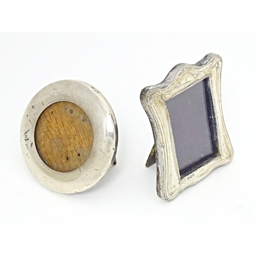 353 - Two easel back photograph frames with silver surrounds, one of circular form hallmarked London 1920,... 