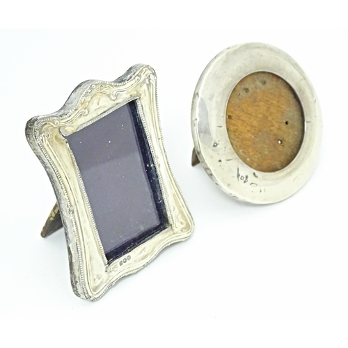 353 - Two easel back photograph frames with silver surrounds, one of circular form hallmarked London 1920,... 