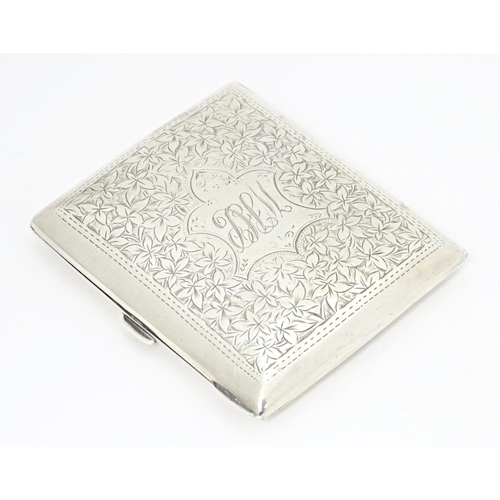 355 - A silver cigarette case of shaped form with engraved foliate detail, hallmarked Birmingham 1904, mak... 