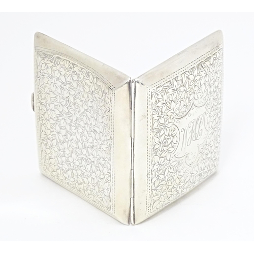 355 - A silver cigarette case of shaped form with engraved foliate detail, hallmarked Birmingham 1904, mak... 