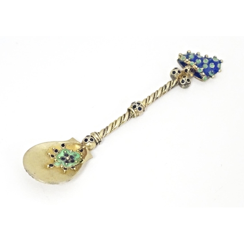 370 - A white metal salt spoon with gilded and enamel decoration in the Russian style. Approx. 2 3/4