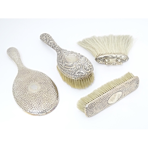 383 - Assorted silver handled / backed items to include a hand mirror with hammered decoration hallmarked ... 