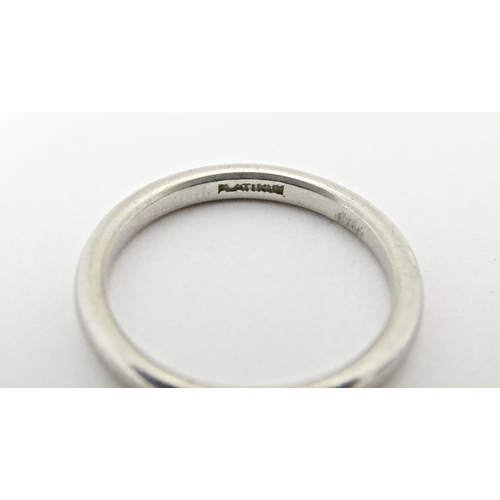 607 - A white metal ring, marked 'platinum'. Ring size approx. J